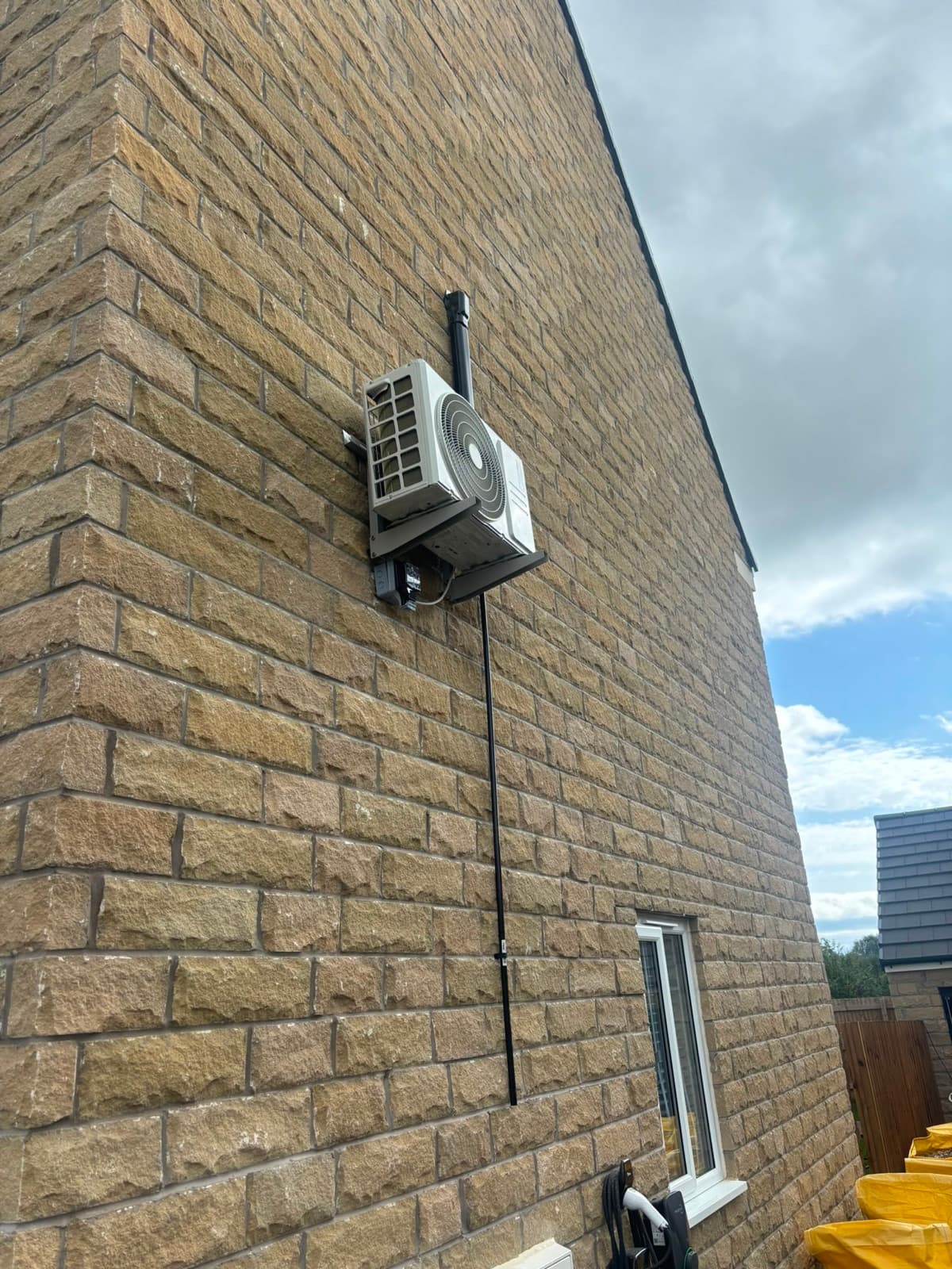 External air conditioning unit on a stone-built house