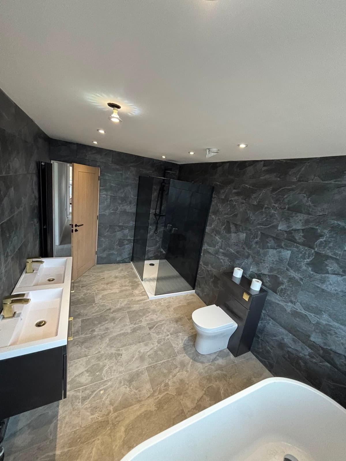 Slate bathroom with a freestanding bath