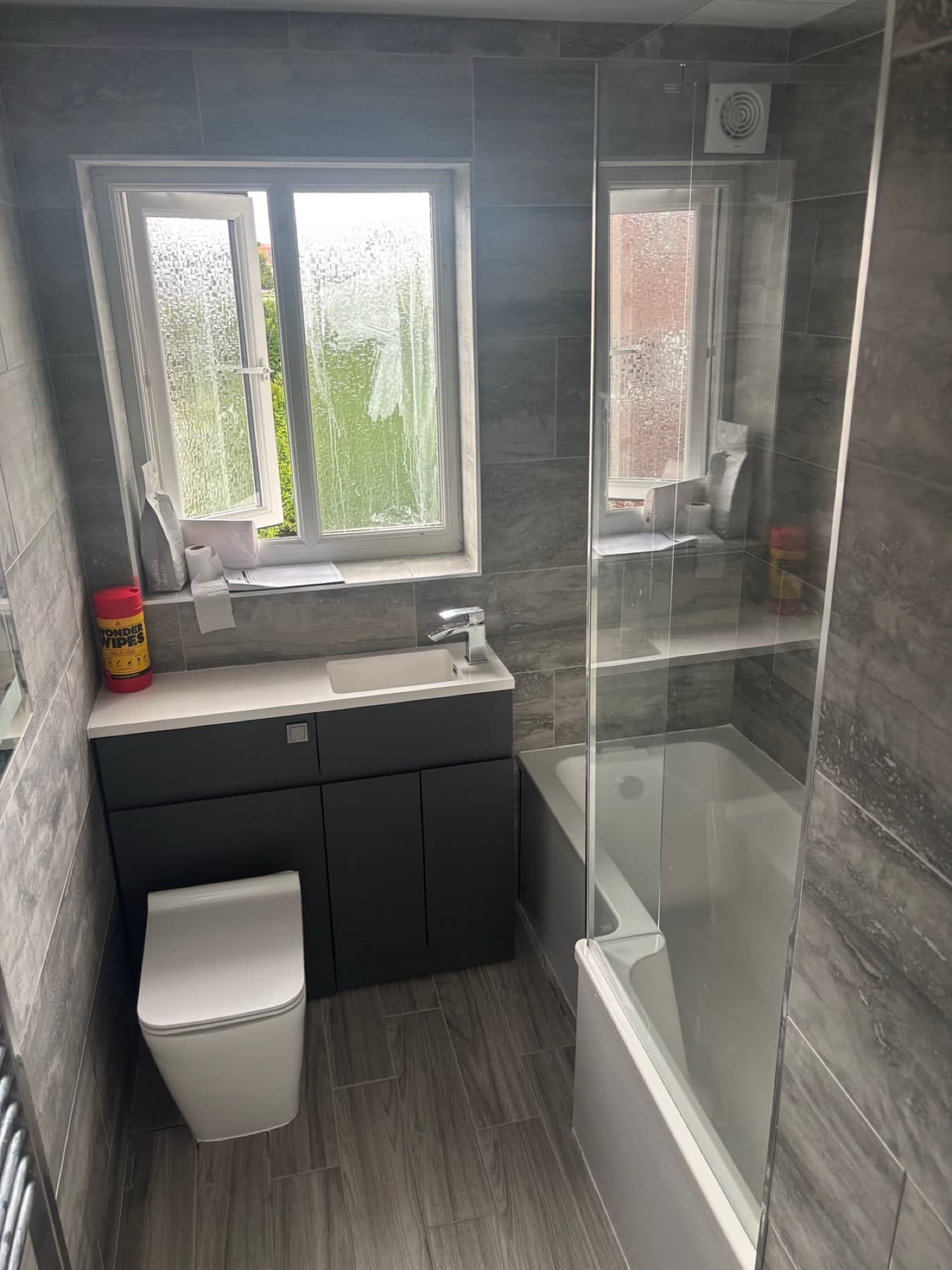 Grey-tiled bathroom with a fitted vanity