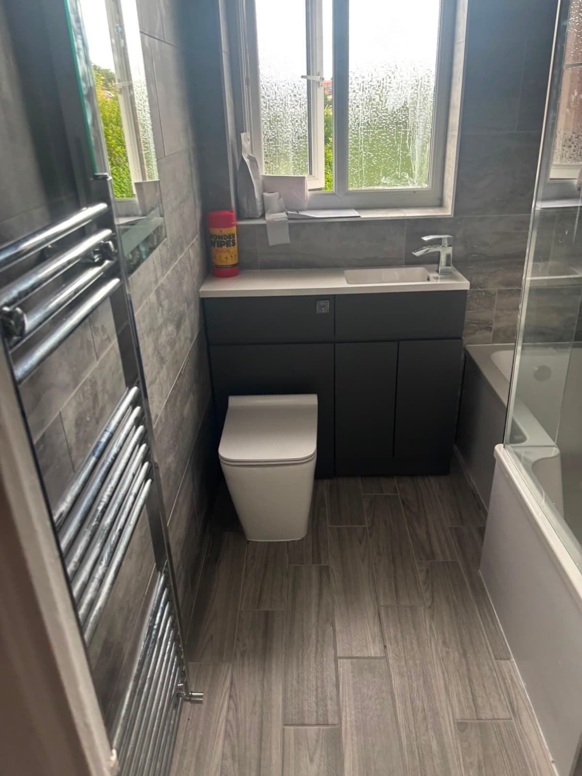 Bathroom with a chrome towel rail and fitted WC