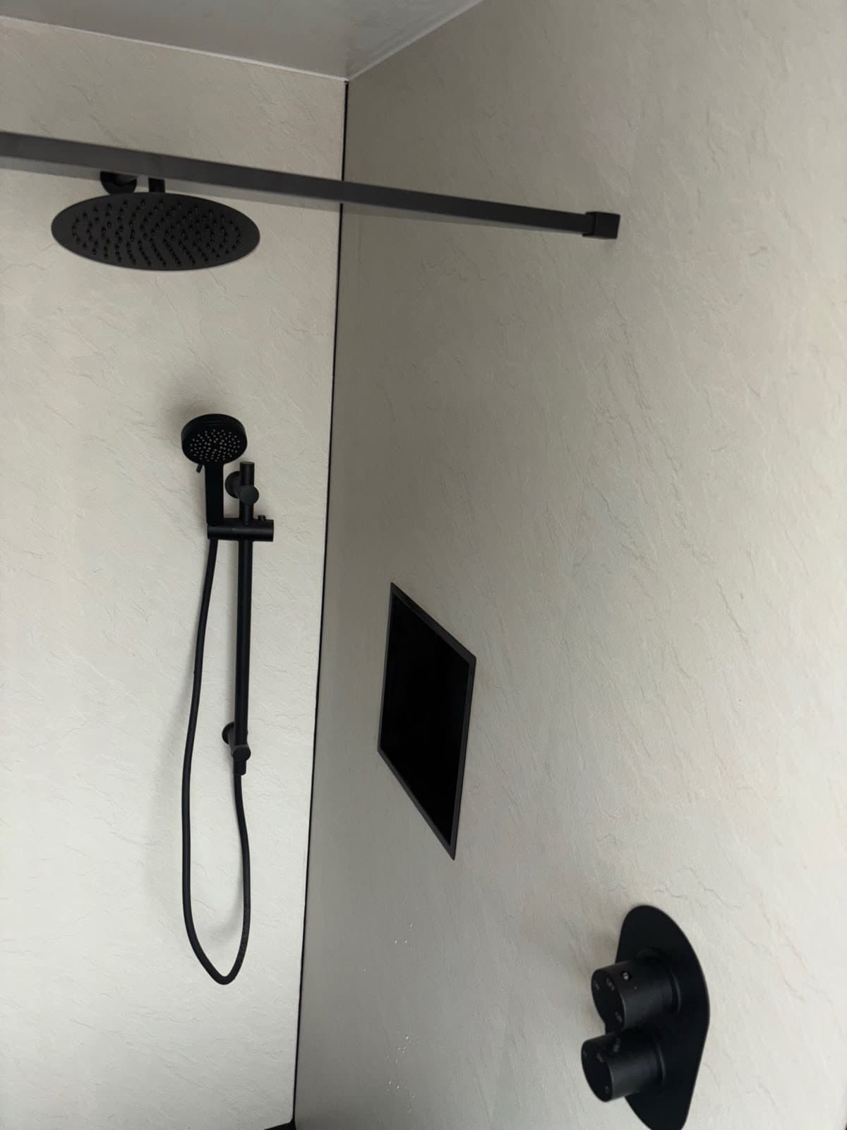 Black shower on slate tile