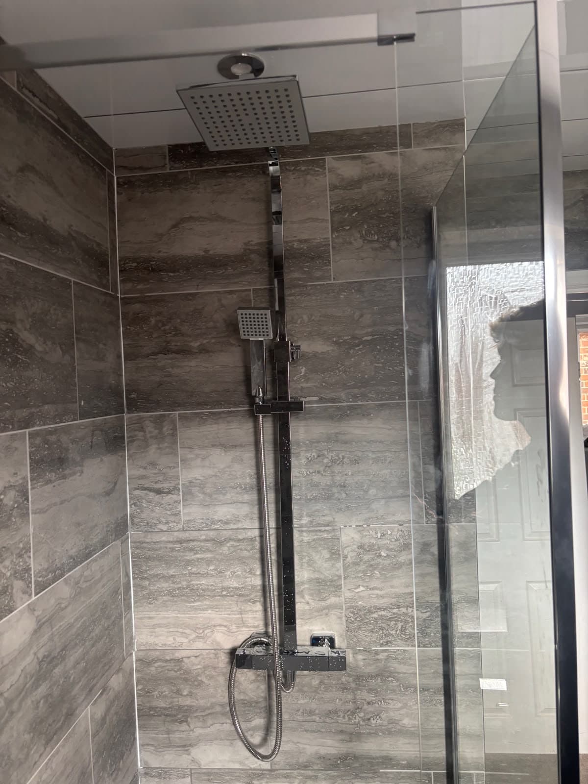 Slate-tiled shower with a glass screen