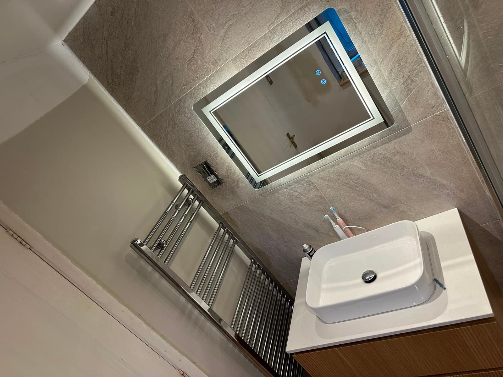 Wide vanity with a backlit mirror
