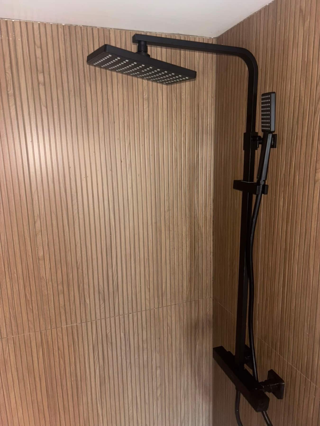 Matte black shower on fluted tile