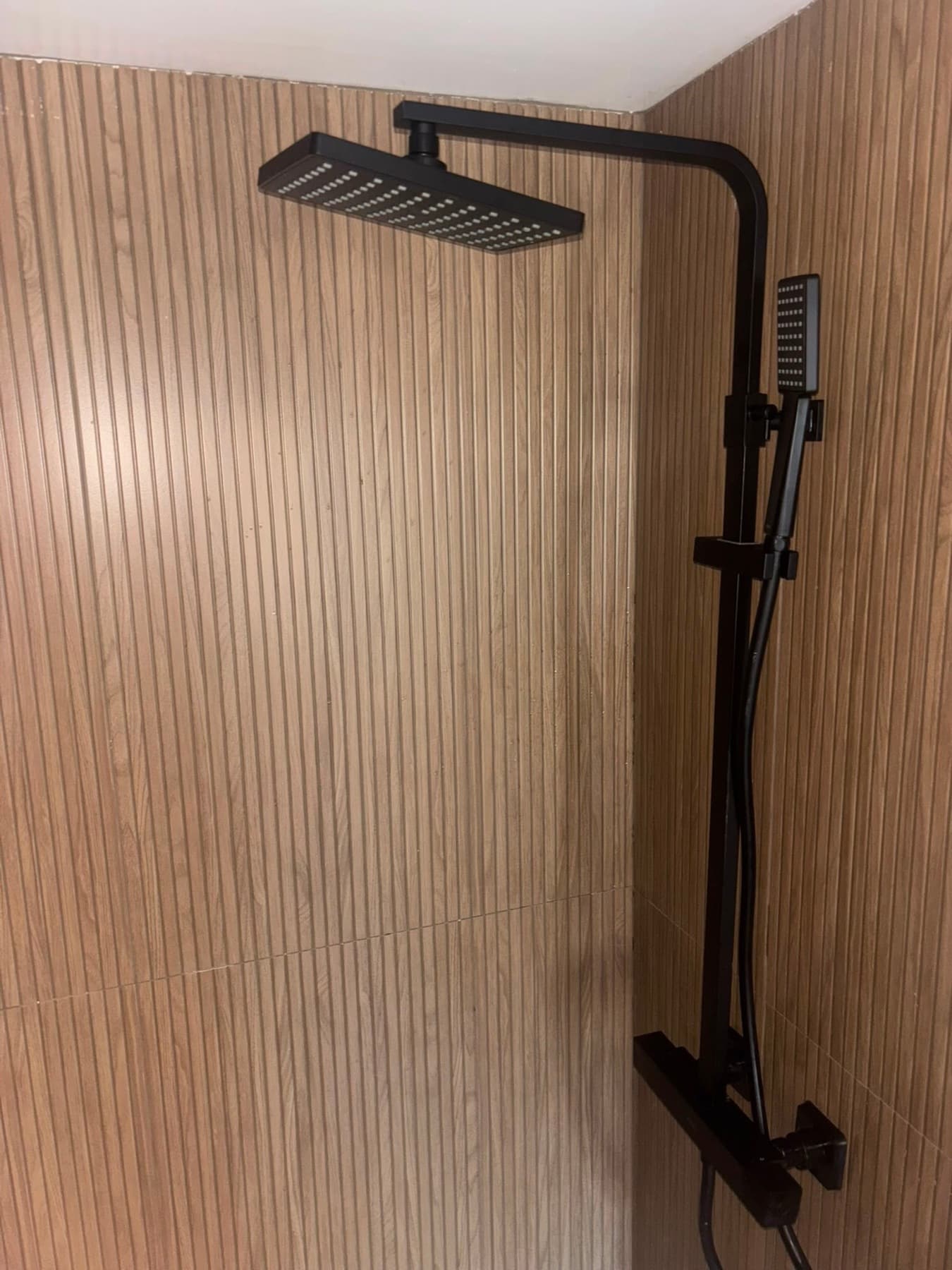 Matte black shower on fluted tile
